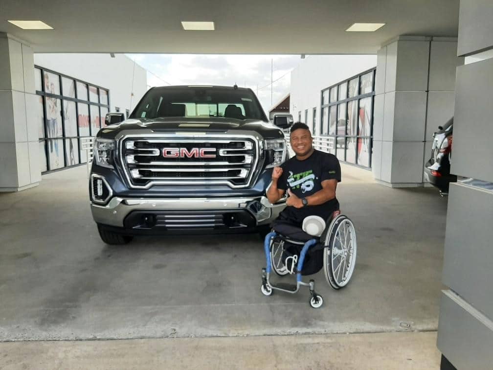 Ryan Major in front of new Ford F-150 gifted by WWFS for Mobility is Freedom campaign