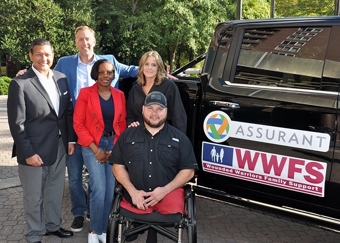 Sean Adams with WWFS team in front of new vehicle for Mobility is Freedom donation