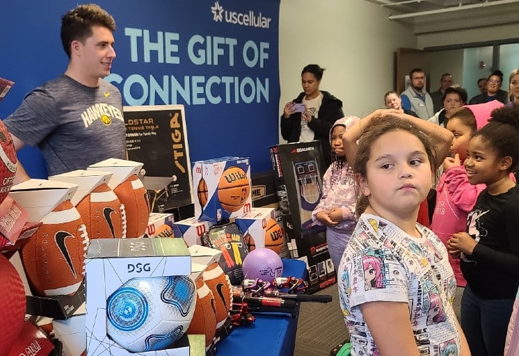 Cade MacNamara meeting kids at Gift of Connection donation event