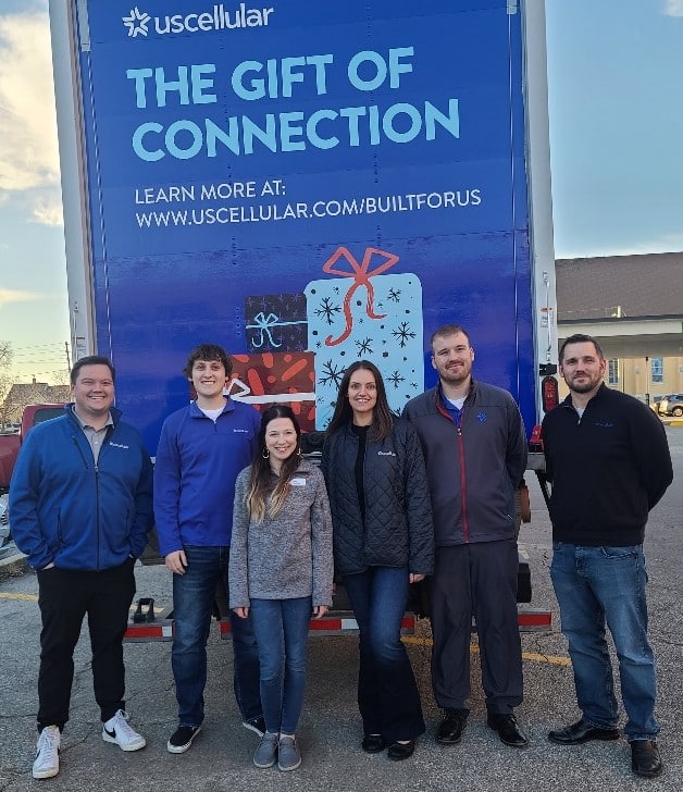 UScellular employees standing in front of Gift of Connection truck