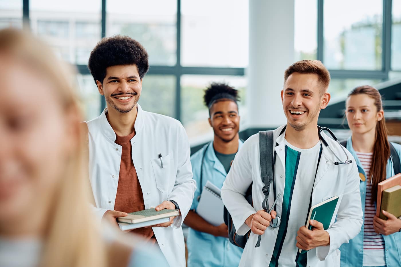 med students walk through the lobby of a hospital together
