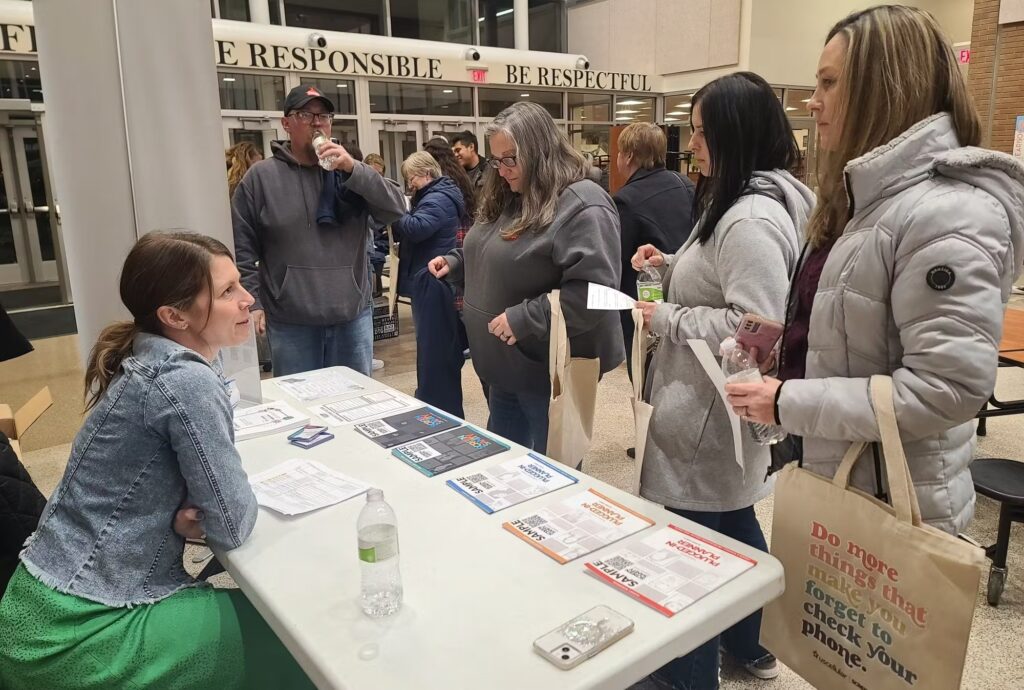 Parents browsing Screen Sanity booth during event for UScellular Global Day of Unplugging PR campaign